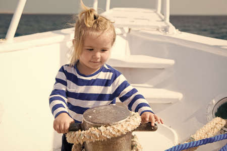 Baby concept. Cute baby sailor. Little baby travel on ship in sea. Baby on summer vacationの写真素材