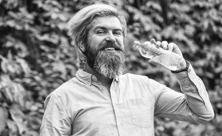 pleasant morning routine. Daily intake of water. Thirsty male model enjoying refreshing drink. Healthy eating and drink. Drinking water. Handsome Man Drinking Fresh Water From bottleの写真素材