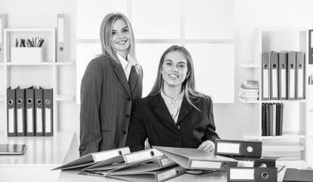 together in business. businesspeople in office. businesswoman at workplace. too much work with documents. friendship. office fashion style. business partnership success. modern office lifeの写真素材