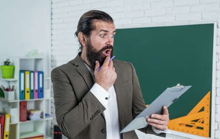 concentration. learning the subject. back to school. happy teachers day. brutal man with beard wear costume. informal education. male student sit in classroom while lesson. pass the examの写真素材