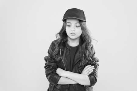Confident small girl child with long brunette hair wear casual fashion style keeping arms crossed yellow background, confidenceの写真素材