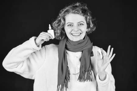 use nasal spray. Coronavirus outbreak concept. sick woman sneezing at home. Holding Handkerchief to Runny Nose. concept of treating allergies or colds. runny nose. woman with allergy blowing her noseの写真素材