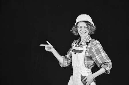 Woman builder in hardhat. Girl engineer or architect. Home renovation. Lady at construction site....