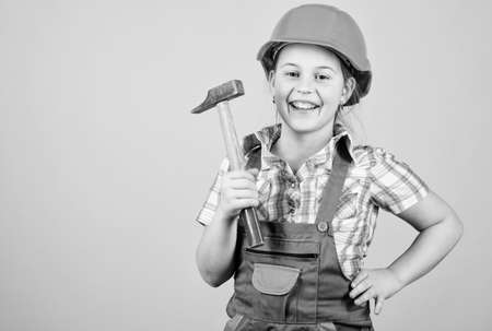 Tools to improve yourself. Builder engineer architect. Future profession. Kid builder girl. Build your future yourself. Initiative child girl hard hat helmet builder worker. Child care developmentの写真素材