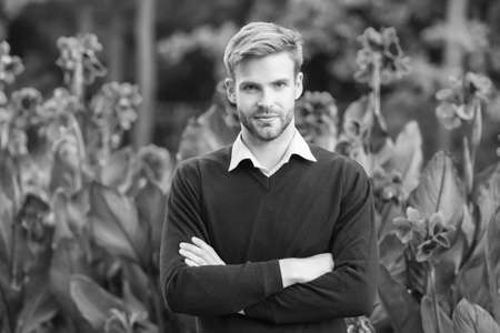 young unshaven man outdoor. male beauty and fashion. guy with bristle wear purple sweater. concept of barbershop. business casual fashion style. Male natural beauty. Man well groomed facial hairの写真素材