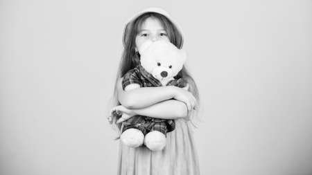 Her favorite toy. Little girl holding soft toy. Small child cuddling teddy bear toy. Adorable girl child with cute stuffed animal doll. Toy is used in playの写真素材