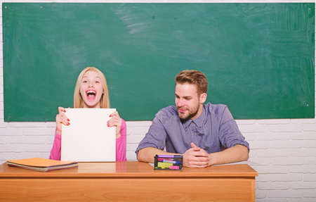 Happy graduate. Student life. Lesson and blackboard. Teachers day. Back to school. Modern school. Knowledge day. Couple of man and woman in classroom. Home schooling. Happy coupleの写真素材