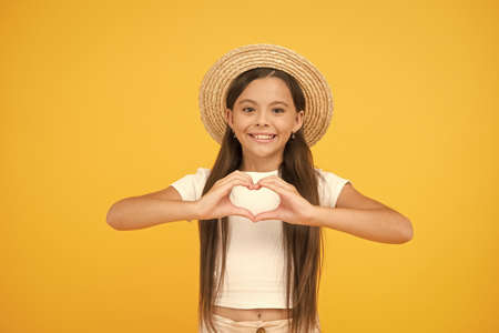 Summer care. Apply right sunscreen. Teen girl summer fashion. Little beauty in straw hat. Beach...
