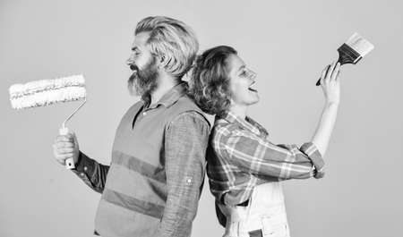 Painting walls. Cheerful couple renovating house. Woman builder. Man painter or decorator. Interior renovation. Decorating apartment. Pick color. DIY repair. Construction workers. Home renovationの写真素材
