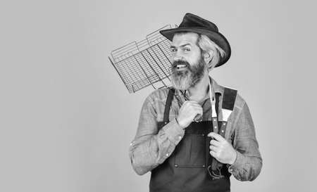 American picnic. Family tradition. Spring season. Cooking meat. Roasting meat. Picnic and barbecue. Steak and barbecue. Barbecue menu. Bearded hipster wear hat and apron for barbecue. Grilling foodの写真素材