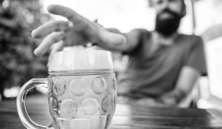 Distinct beer culture. Mug cold fresh beer on table close up. Man sit cafe terrace enjoying beer...