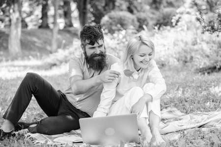 Couple youth spend leisure outdoors working with laptop. How to balance freelance and family life. Couple in love or family work freelance. Freelance life benefit concept. Modern online businessの写真素材