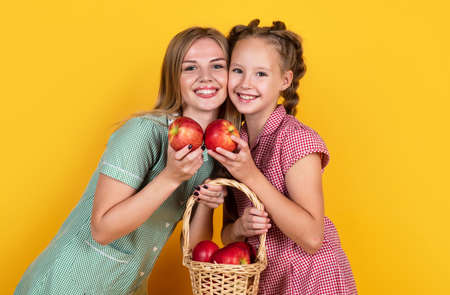 happy family of mother and daughter with red apple fruit, family healthの写真素材