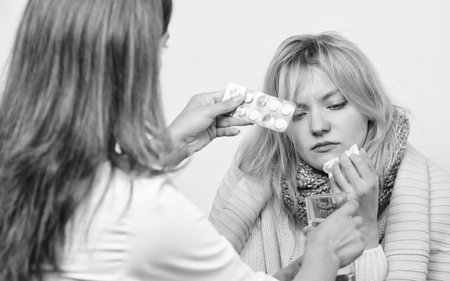 The drug is available on prescription only. Patient care and healthcare. Primary care doctor making diagnosis to sick woman. Medical doctor examining patient. Doctor visiting unhealthy woman at homeの写真素材