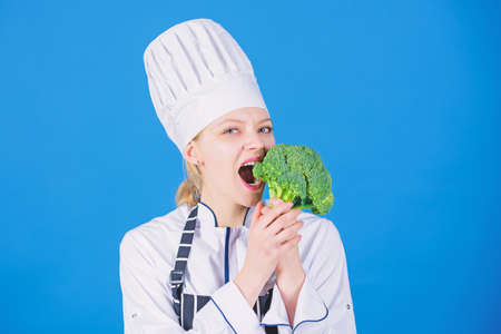 Woman professional chef hold raw broccoli vegetable. Free healthy vegetarian and vegan recipes. Healthy raw food. Dieting concept. Eat healthy. Girl wear hat and apron hold vegetable. Healthy rationの写真素材