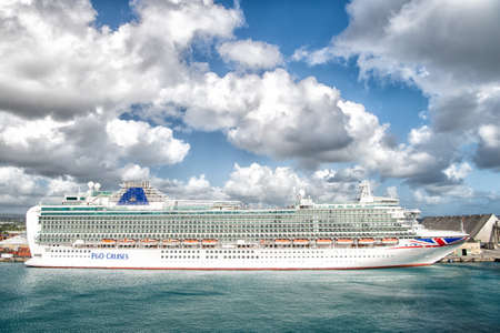 P O Cruises. Azura cruise ship docked in sea port on cloudy sky. Cruise ship transportation. Travelling by cruise sea ship. Cruise ship summer vacationのeditorial素材