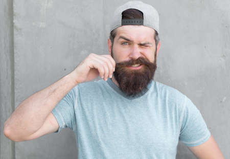Grow mustache. Cool hipster with beard wear cap. Barber salon and facial hair care. Hipster lifestyle. Brutal handsome mature hipster man. Bearded man trendy style. Beard and mustache groomingの写真素材