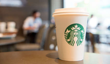 Berlin, Germany - May 31.2017: starbucks coffee cup in cafe shop, copy space. starbucks is largest coffee house with famous emblem. takeaway coffee. perfect morning with starbucksのeditorial素材