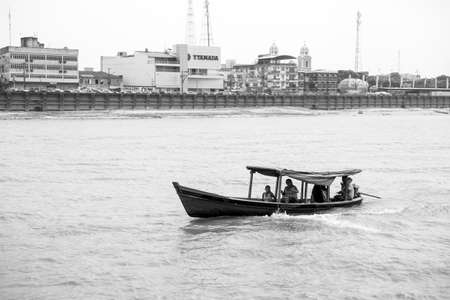 Santarem, Brazil - December 02, 2015: boat with people on amazon river. Motorboat float along river bank with houses. Travel by water transport. Summer vacation and wanderlust conceptのeditorial素材