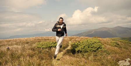 bearded handsome man jogger run on mountain top