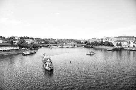 Prague, Czech Republic - June 03, 2017: Pleasure boats on Vltava river. travel by water transport. Holiday cruiser ships on cityscape on blue sky. Summer vacation and wanderlustのeditorial素材