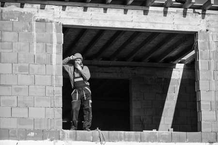 repairman engineer wear helmet on site. tired builder relax. construction worker smoking cigarette....