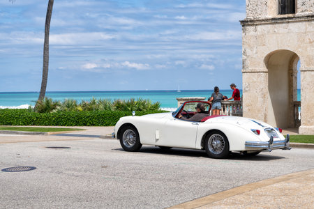 Palm Beach, Florida USA - March 21, 2021: man driving Classic Jaguar XK 150 3.8 Roadster retro carのeditorial素材