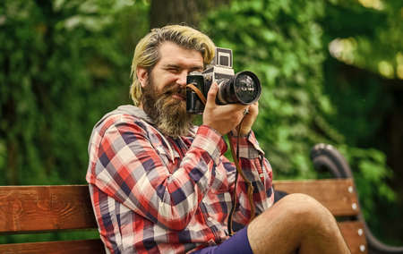 Find perfect angle. Man with retro camera. Photography in modern life. Photographer use vintage...