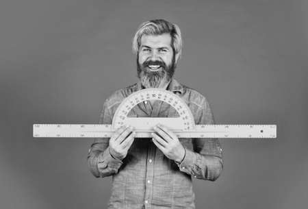 calculations in physics. back to school. favorite subject and disciplines. Education at school. home learning concept. man teacher use protractor tool. bearded tutor man with ruler. draw and measureの写真素材