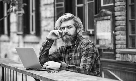 communication by video call. businessman with laptop and phone sitting in cafe. Handsome man working on his laptop. business man working outdoors with computer. start video conferencingの写真素材