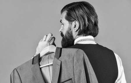 my choice. Man with suit. tailor in his workshop. Handsome bearded fashion man in classical costume suit. Man in custom tailored suit presenting expensive tailored tuxedo. Man clothing in boutiqueの写真素材