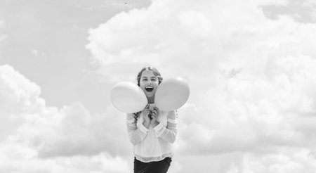 Party fun. childhood happiness. feeling free and carefree. kid in spring holiday. cheerful child have fun. happy birthday party. small girl with party balloon. summer holidays and vacationの写真素材