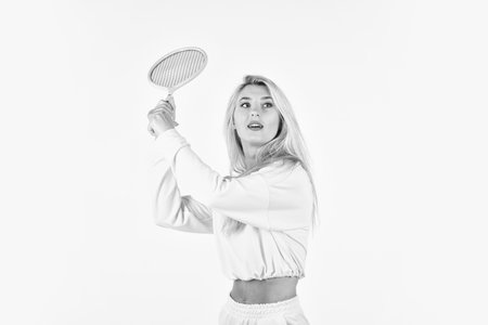 Dedicated to fitness. female tennis player isolated on white. girl with tennis racket. active playing on court. squash game activity. Sport and sportswear fashion. sporty woman hold tennis racquetの写真素材