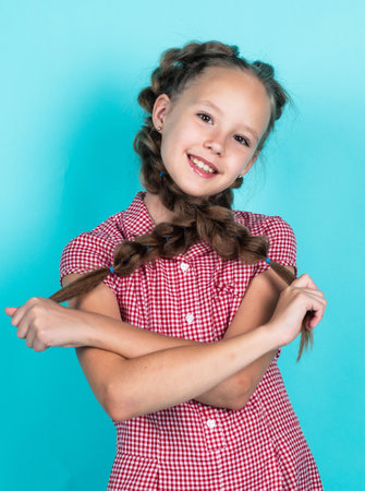 happy teen girl with braided hair in pigtails, childhoodの写真素材
