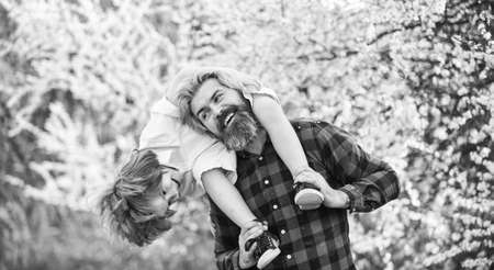 Best weekend ever. love and support. father and son at blooming tree. spring time together. little boy happy with dad. family having fun. blossoming tree in park. childhood and parenthood happinessの写真素材