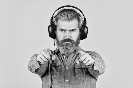 try this. Listening to music. Time to relax. brutal hipster wear earphone. singing and dancing. Enjoying his favorite music. Man listening music with his headphones. bearded man hipster in headsetの写真素材