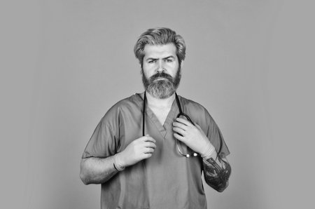 Free medicine concept. Professional doctor. Insurance. Stay healthy. Doctor with stethoscope at hospital. Bearded man doctor. Medical treatment. Prescribed by doctor. Health care. Medical educationの写真素材