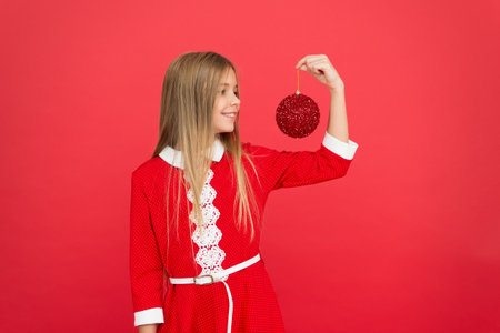 elf kid decorative tree ball. feeling happy about xmas holiday. christmas shopping time. ready for new year celebration. Festive mood. Create unique decorations. small girl child red wallの写真素材