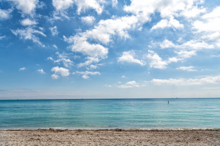 amazing daylight seascape with cloudy sky over sea or ocean water with ships on horizon, beachの写真素材