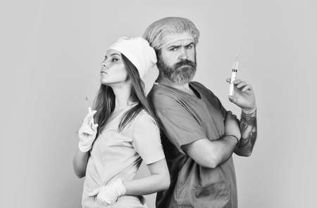 nurse and doctor use syringe. injection virus vaccine. infection vaccination. Liquid drug or narcotic. health and medicineの写真素材