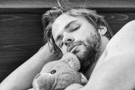 Man stretching in bed. Stretch after wake up in the morning. Wake early.の写真素材