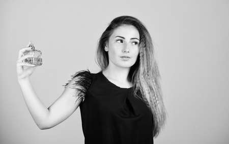 Never let go. sexy girl hold perfume. scented water cologne in spray bottle. woman with bottle of perfume. Girl applying perfume. find your fragrance. luxury lotion. cosmetic careの写真素材