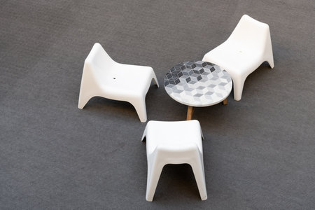 Modern plastic chairs and table on grey floor, furnitureの写真素材