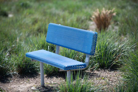 Blue plastic vacant park seat natural background, bench.