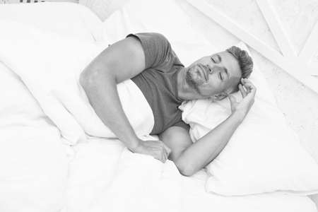 Sleeping handsome. Bearded man sleeping face relaxing on pillow. Handsome and sleepy. Sexy man sleeping in bed. Guy lying in bed try to relax and fall sleep. Enjoying beautiful morningの写真素材