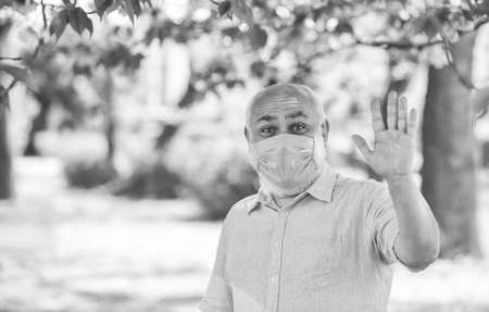 Support elderly during coronavirus lockdown and social distancing. Safety measures. Coronavirus pandemic. Senior man wearing face mask. Pandemic concept. Stop pandemic. Do not touch your faceの写真素材