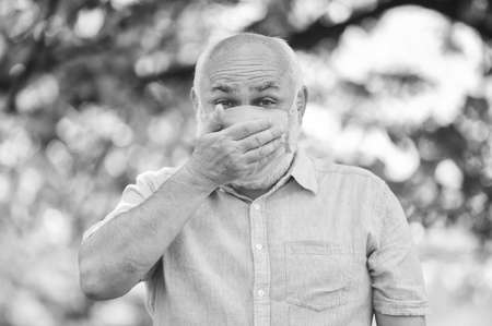 Coronavirus pandemic. Pandemic concept. Pandemic outbreak. Do not touch your face. Support elderly during coronavirus lockdown and social distancing. Senior man wearing face mask. Safety measuresの写真素材