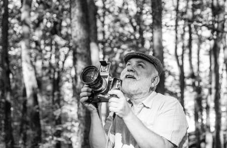 Retro Camera. Capture the moment. Pension and retirement. Vintage stylized photo of man photographer...