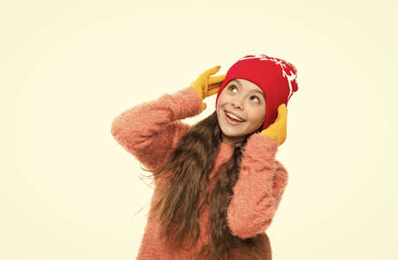 little girl in hat christmas pattern. winter holiday wonder. child knitted hat isolated on white. cold winter weather. warm clothes and accessory fashion for kids. happy childhood activityの写真素材