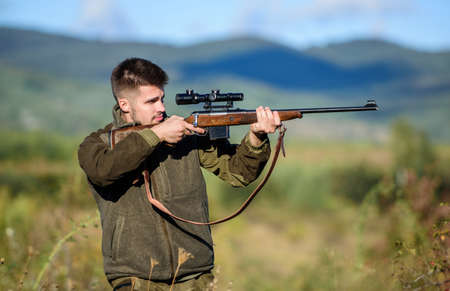 Hunter hold rifle. Focus and concentration of experienced hunter. Hunting and trapping seasons....